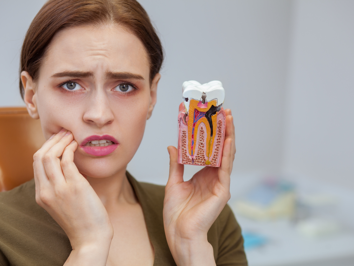 A woman experiencing a severe toothache is experiencing a dental emergency